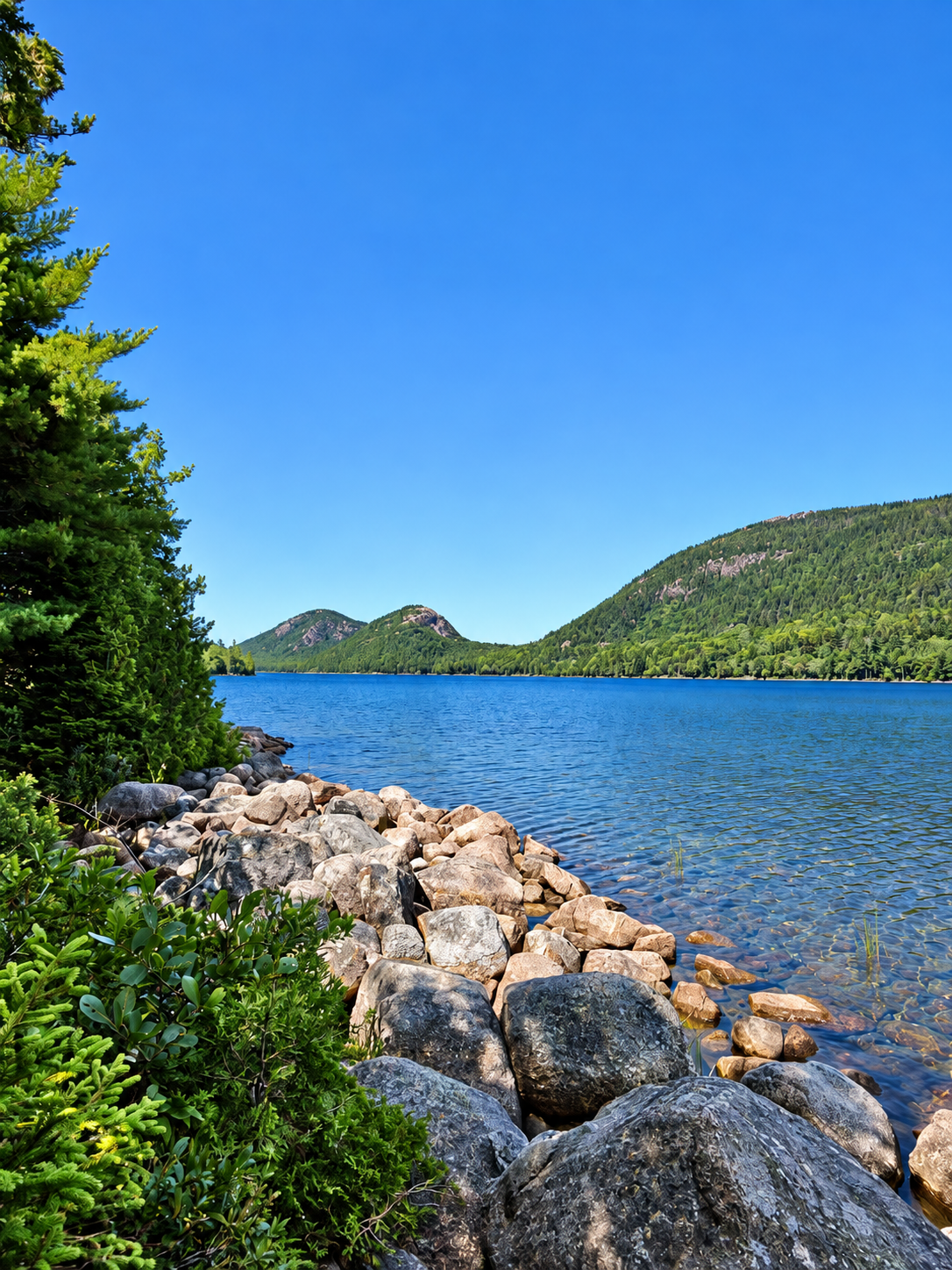 Sunset over Acadia's island-dotted coastline beneath a deep blue sky