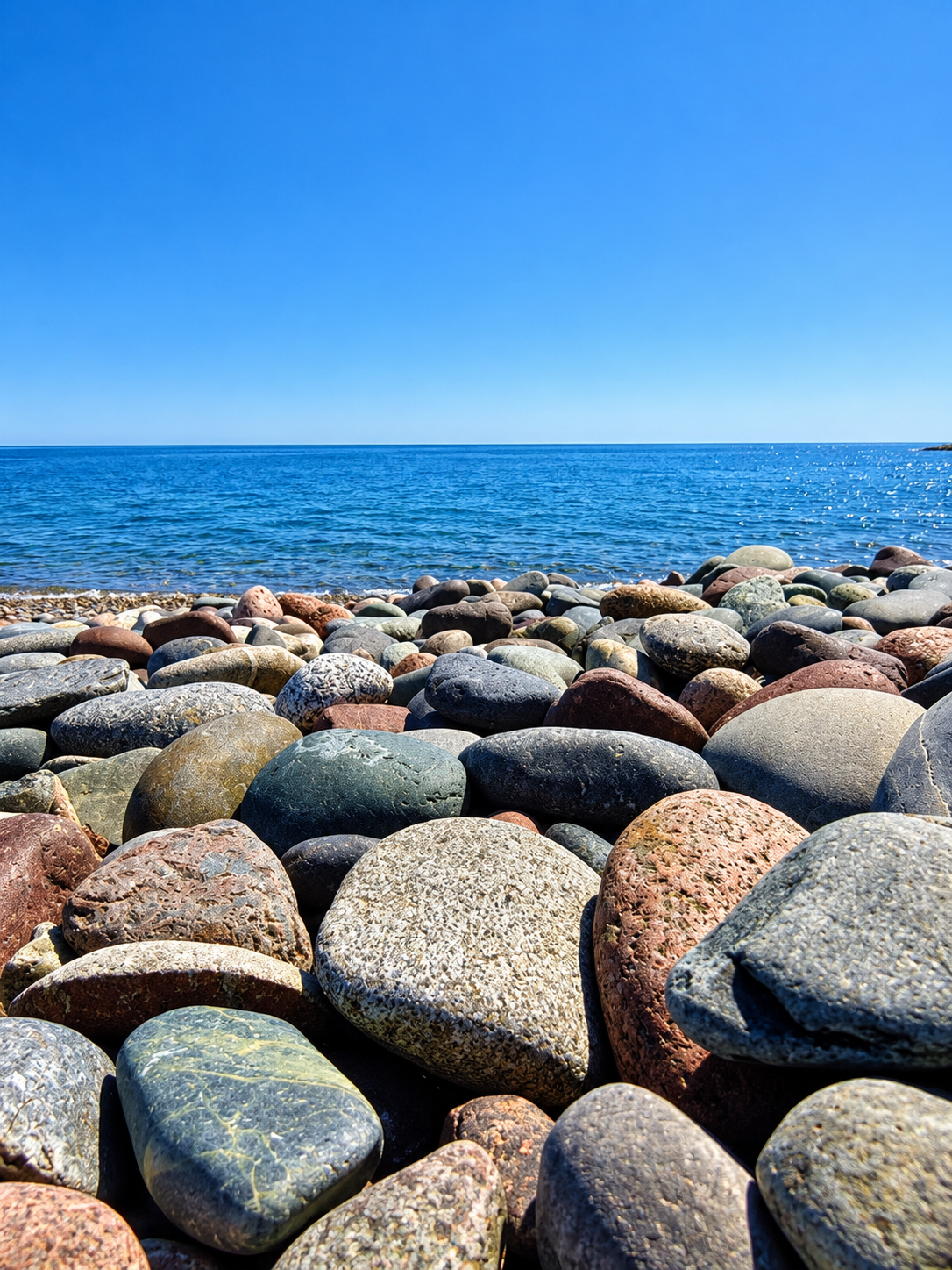 Colorful smooth rocks along the shoreline at Herring Cove