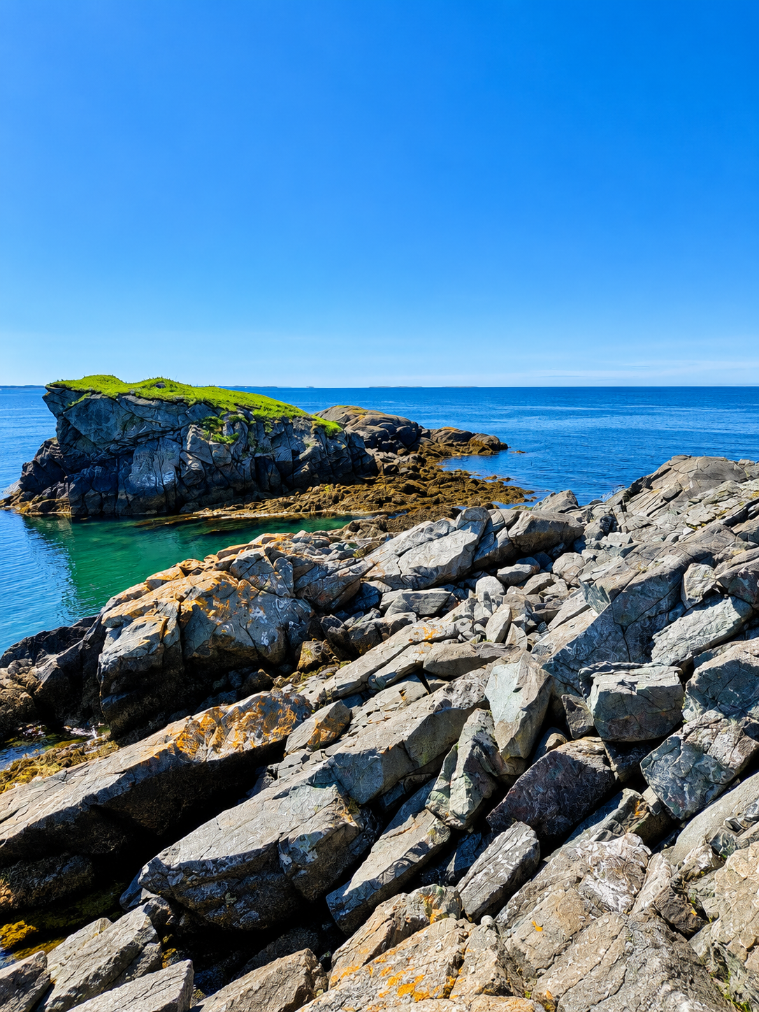 Rocky coastline and clear turquoise water at Liberty Point on Campobello Island