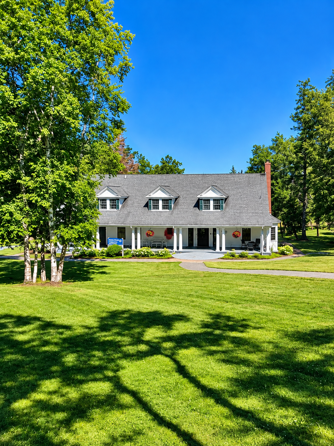 Prince Cottage on Campobello Island surrounded by lawn and trees