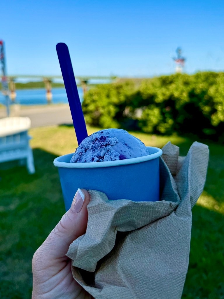 Maine blueberry ice cream held by the water at dusk