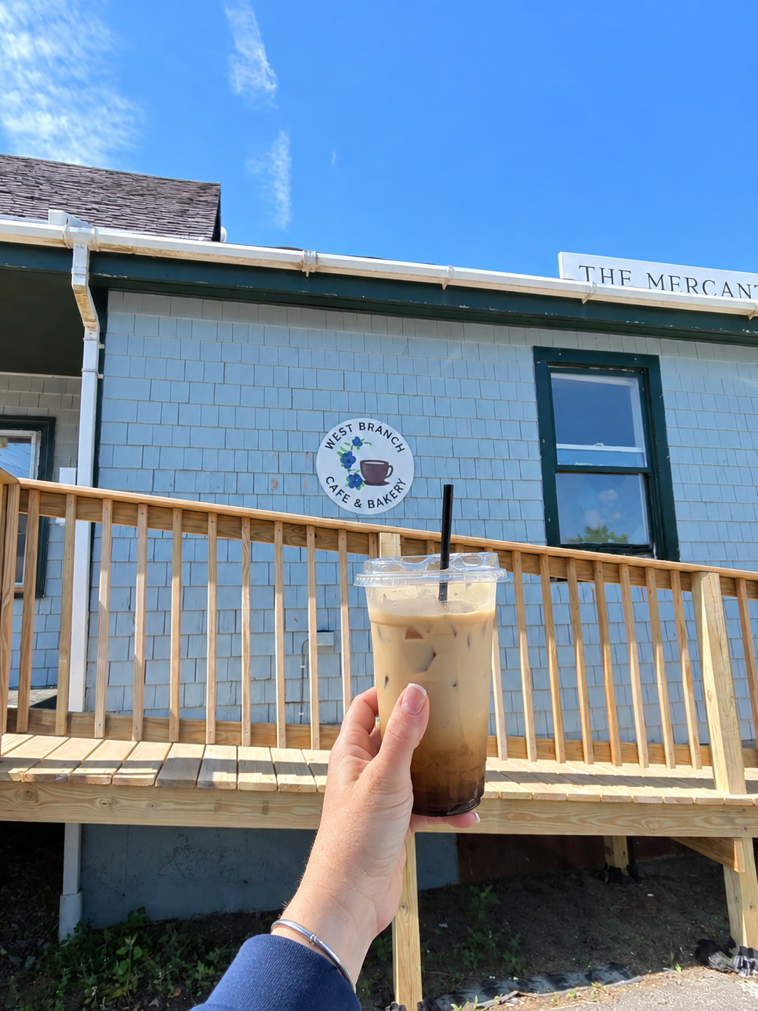 Iced blueberry coffee held outside West Branch Cafe in Maine