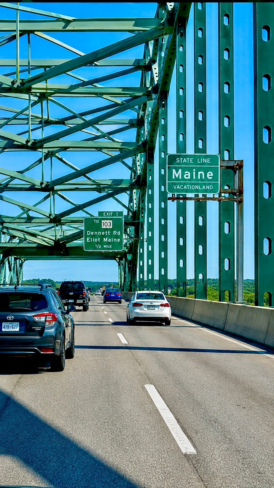 Maine Vacationland state line sign on a steel bridge