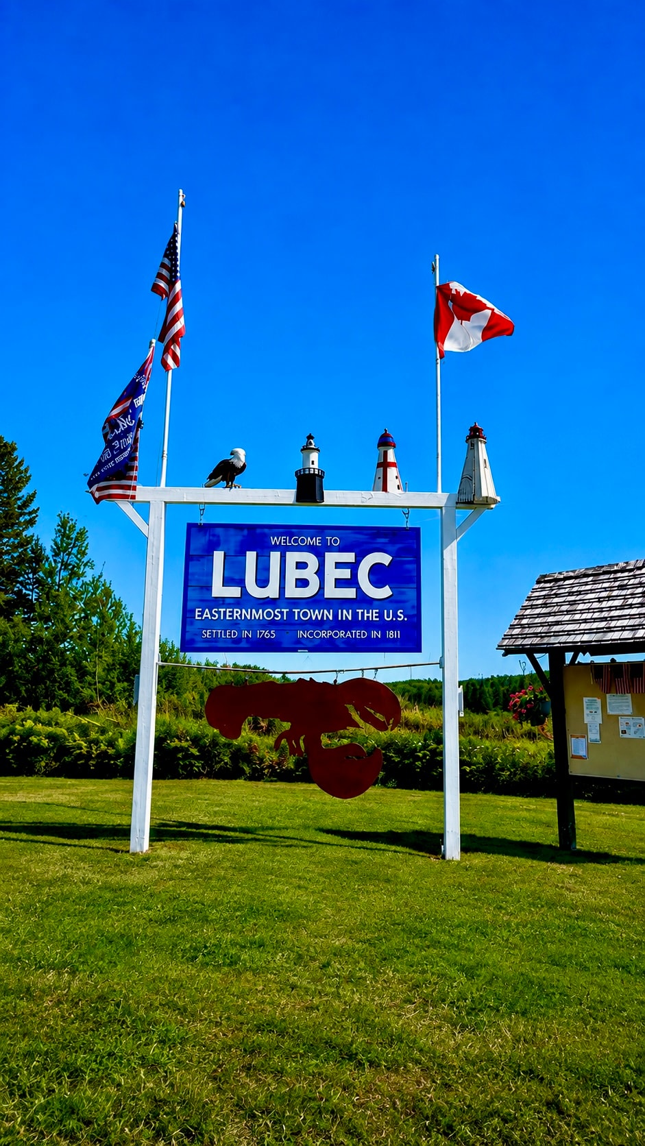 Welcome to Lubec sign with American and Canadian flags